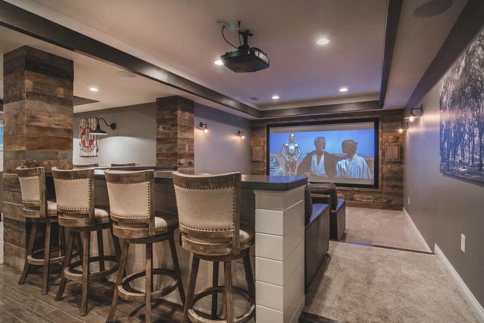 This is an example of a medium sized rustic open plan home cinema in Columbus with grey walls, carpet, a projector screen and beige floors.