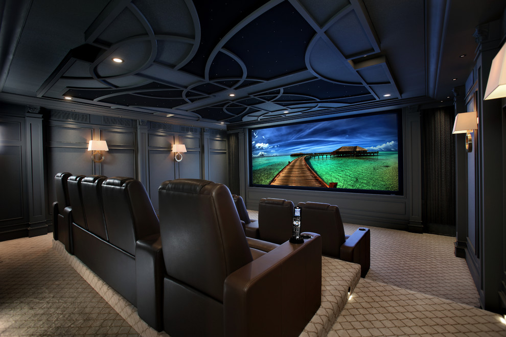 This is an example of a large traditional enclosed home cinema in Toronto with grey walls, carpet and a projector screen.