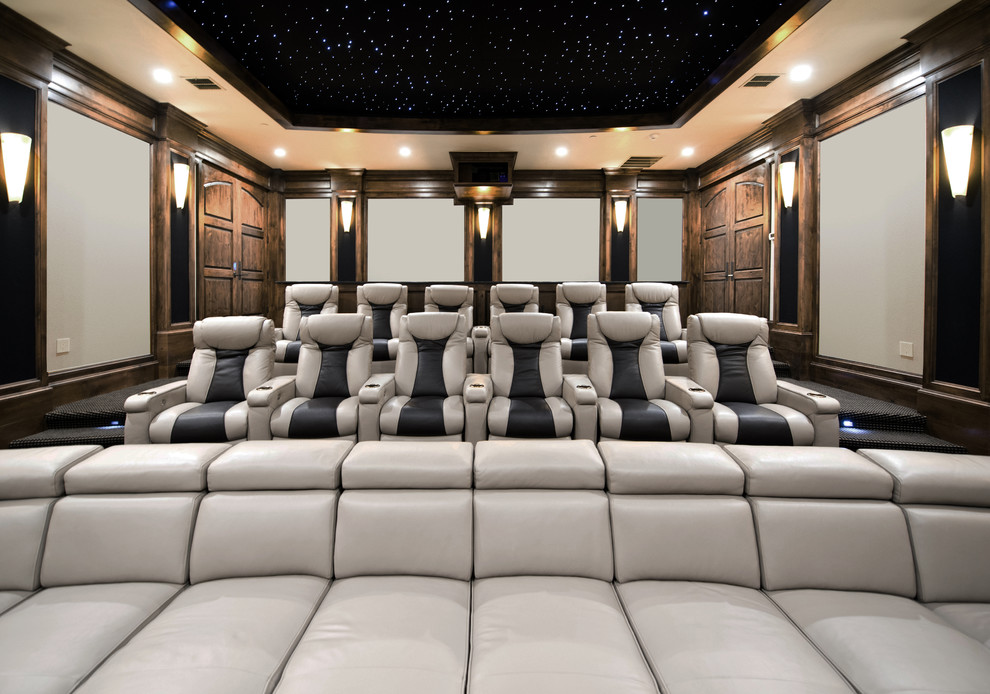 Home theater - huge traditional enclosed carpeted home theater idea in Austin with a projector screen and gray walls