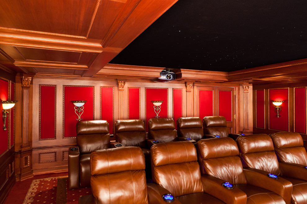 Home theater - mid-sized traditional enclosed carpeted and red floor home theater idea in New York with brown walls and a media wall