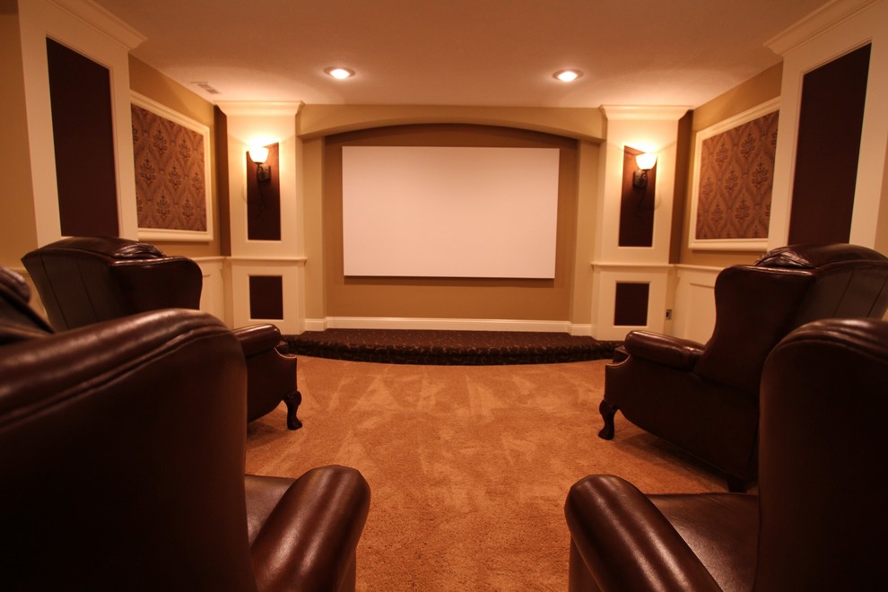 Inspiration for a large classic enclosed home cinema in Kansas City with beige walls, carpet, a projector screen and beige floors.