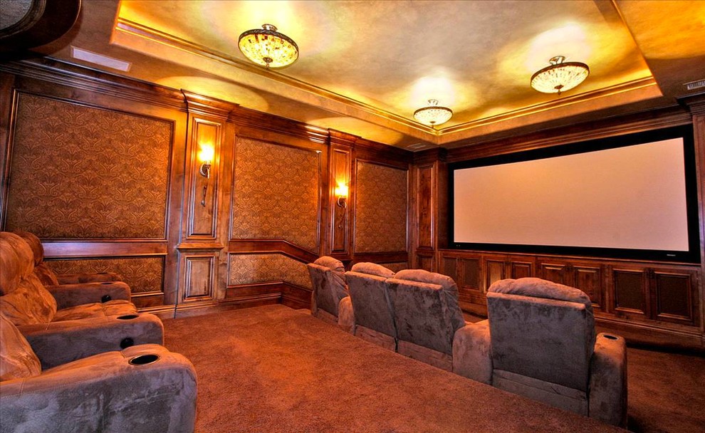 Example of a large classic enclosed carpeted and brown floor home theater design in San Diego with brown walls and a projector screen