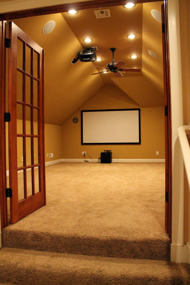 Inspiration for a large timeless enclosed carpeted home theater remodel in Other with beige walls and a projector screen