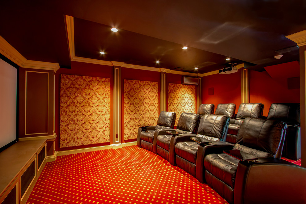 Medium sized traditional enclosed home cinema in New York with red walls, carpet, a projector screen and red floors.