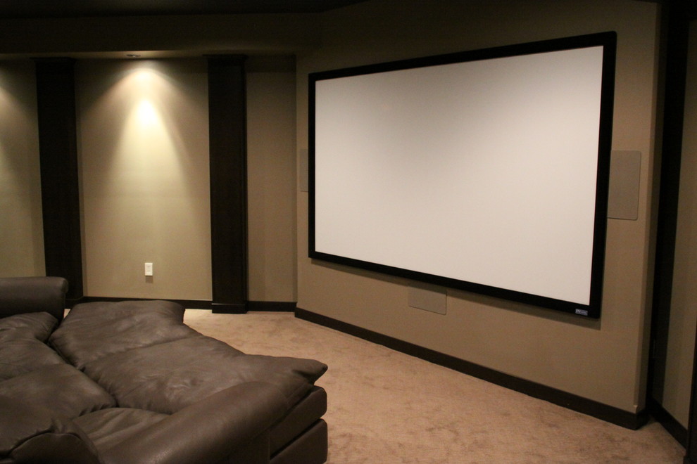 Large contemporary enclosed home cinema in Other with a projector screen, black walls and carpet.