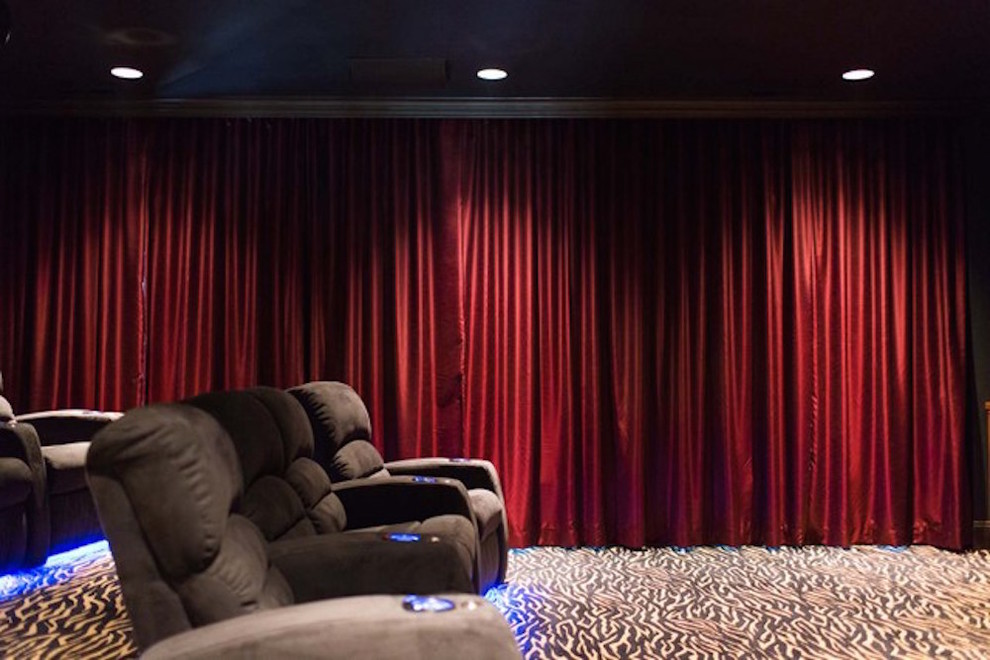 Example of a large classic enclosed carpeted and multicolored floor home theater design in Charlotte with a projector screen and beige walls