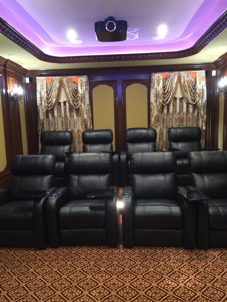 This is an example of a medium sized contemporary enclosed home cinema in Los Angeles with yellow walls, carpet, a projector screen and red floors.