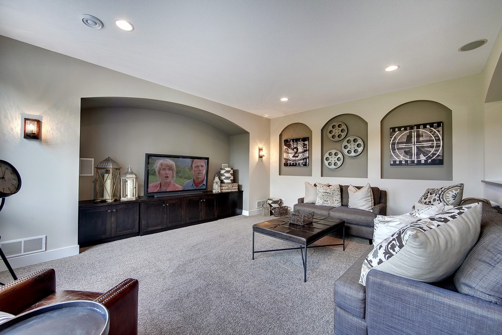 This is an example of a large traditional open plan home cinema in Minneapolis with beige walls and carpet.