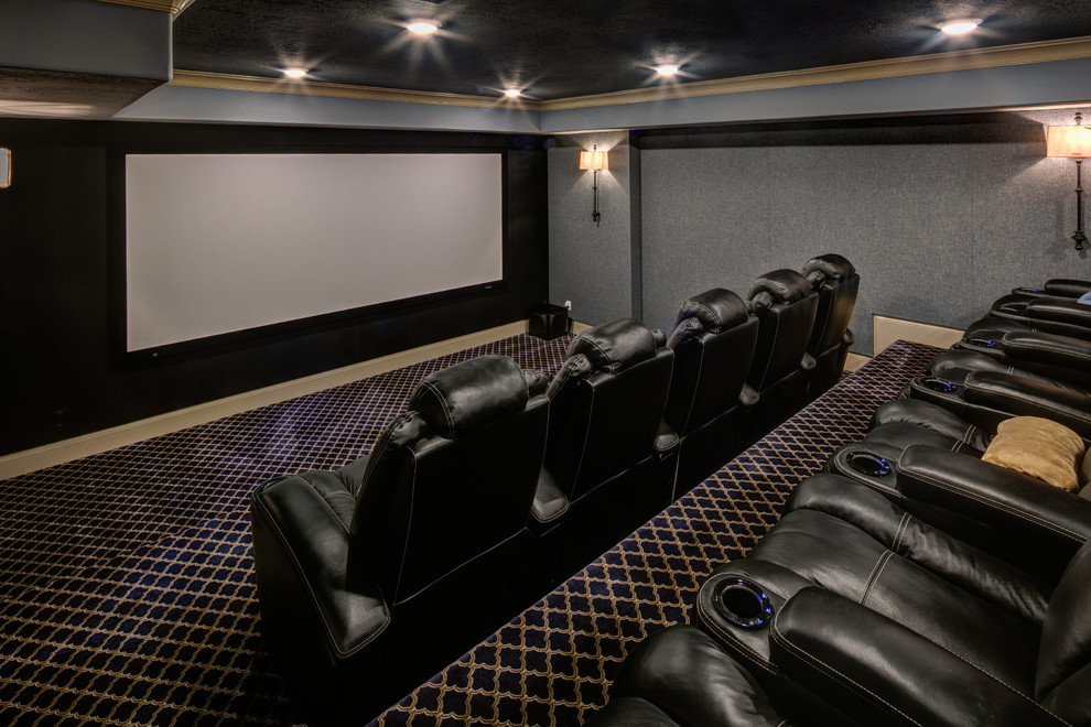 Пример оригинального дизайна: большой изолированный домашний кинотеатр в классическом стиле с серыми стенами, ковровым покрытием, проектором и разноцветным полом