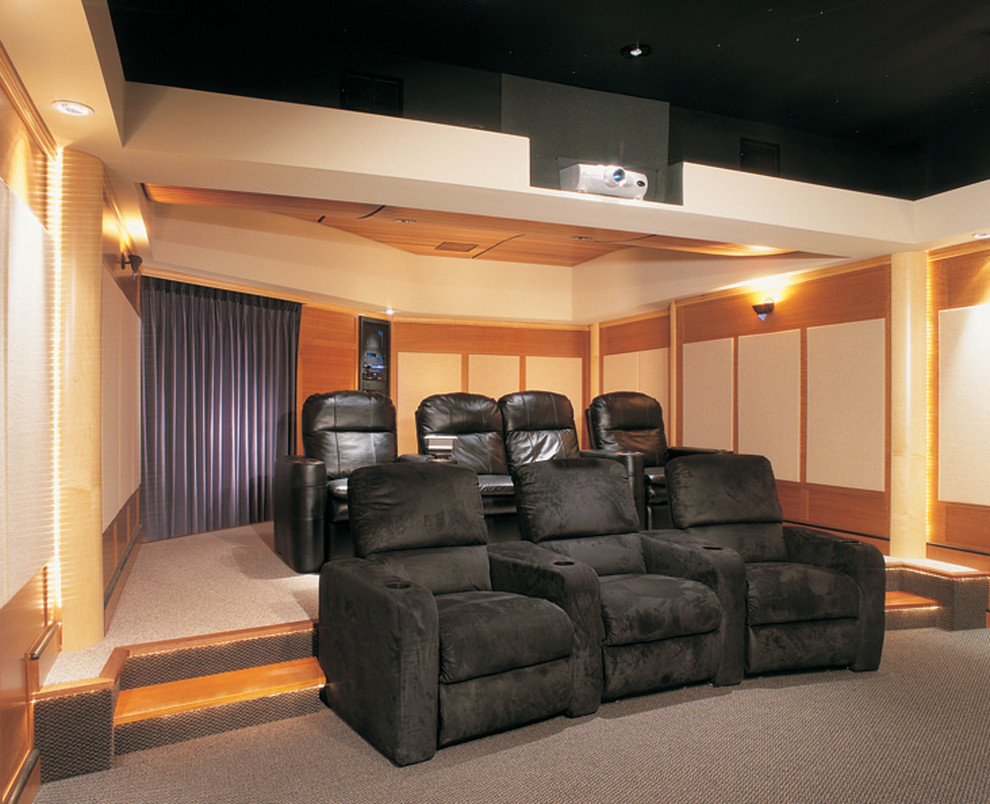 Inspiration for a large timeless enclosed carpeted home theater remodel in Philadelphia with beige walls and a media wall