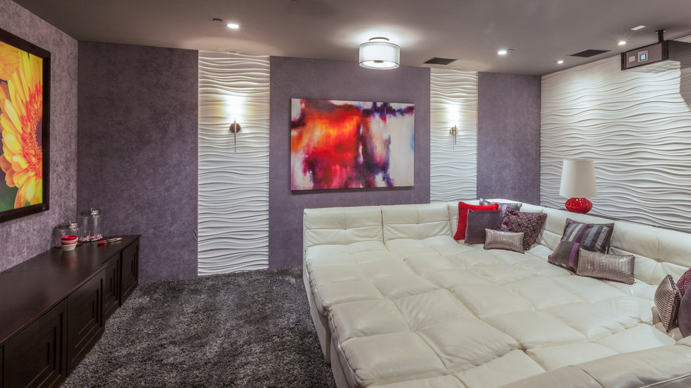 This is an example of a large contemporary enclosed home cinema in Dallas with beige walls, carpet and a projector screen.