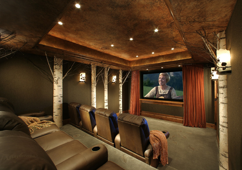 Esempio di un grande home theatre tradizionale chiuso con pareti marroni, moquette, schermo di proiezione e pavimento verde