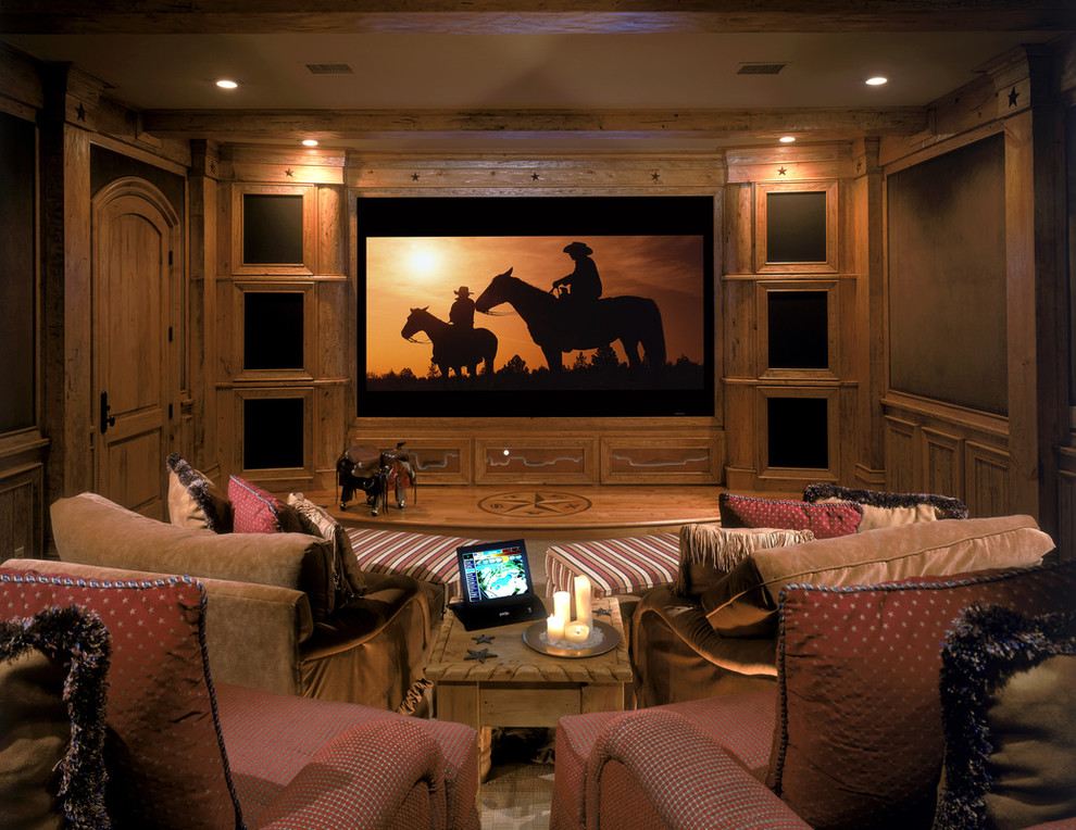 Large island style enclosed carpeted home theater photo in San Diego with beige walls and a projector screen
