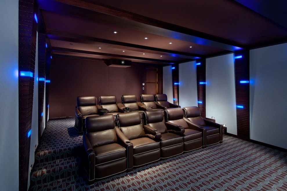 Inspiration for a medium sized classic enclosed home cinema in Orange County with brown walls, carpet, a projector screen and multi-coloured floors.