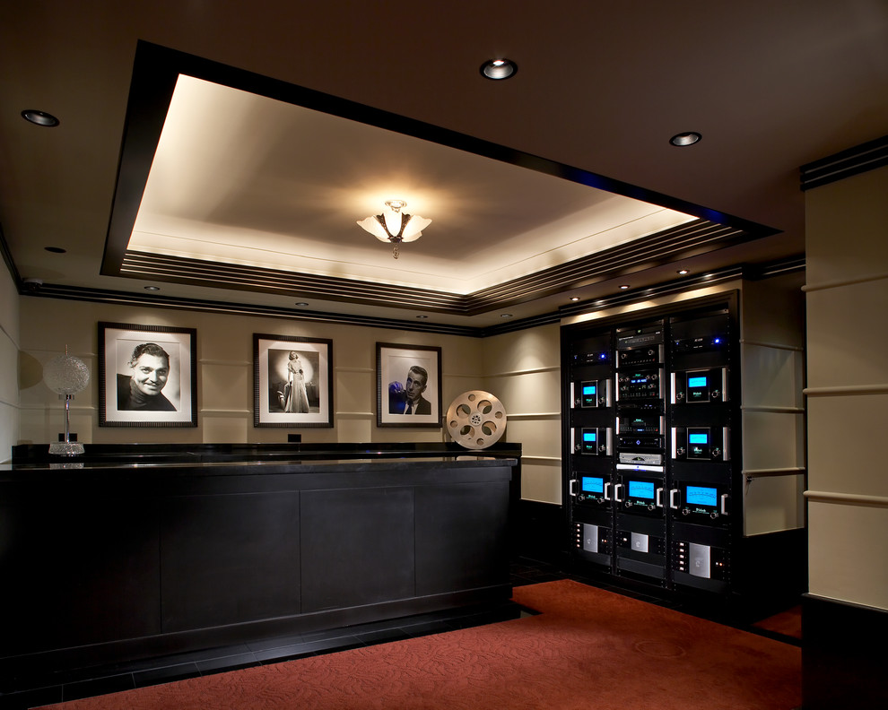 This is an example of a modern enclosed home cinema in New York with beige walls, carpet and red floors.