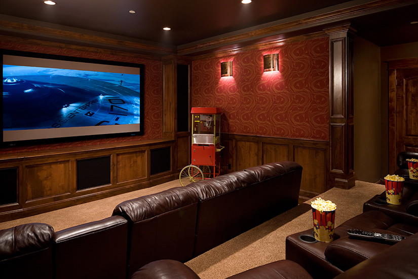 Large elegant enclosed carpeted home theater photo in Denver with a media wall