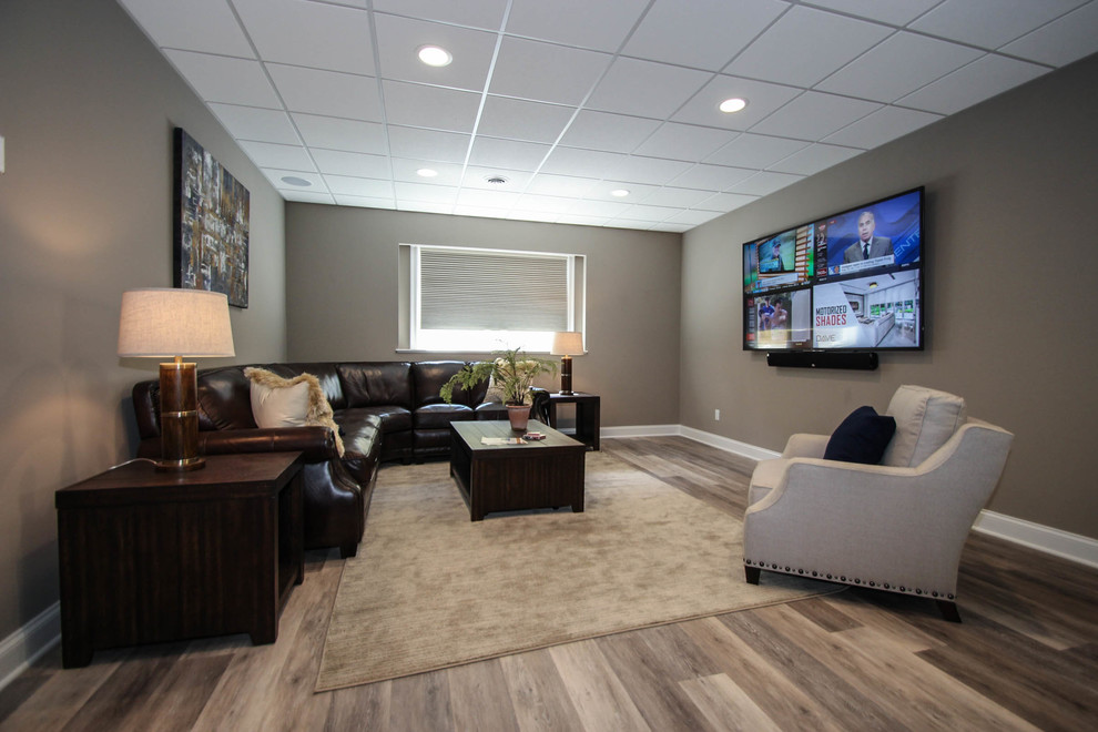 Example of a large transitional enclosed medium tone wood floor and brown floor home theater design in New York with brown walls and a projector screen