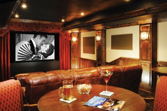Inspiration for a large traditional enclosed home cinema in Other with brown walls, carpet and a projector screen.