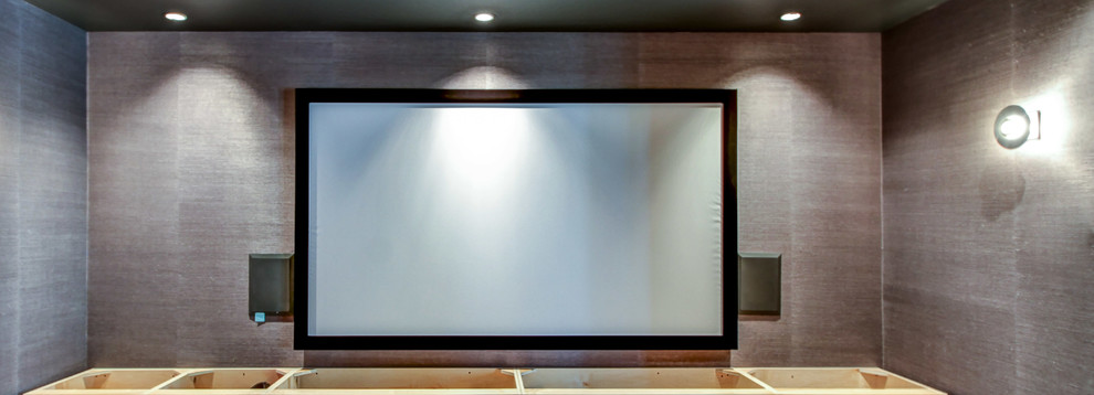 Example of a large urban enclosed home theater design in Other with gray walls and a projector screen