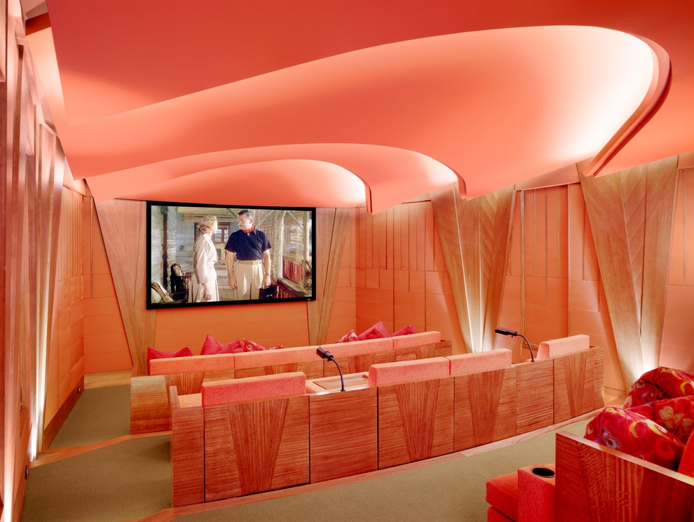 Inredning av ett exotiskt avskild hemmabio, med rosa väggar, heltäckningsmatta, en väggmonterad TV och grönt golv