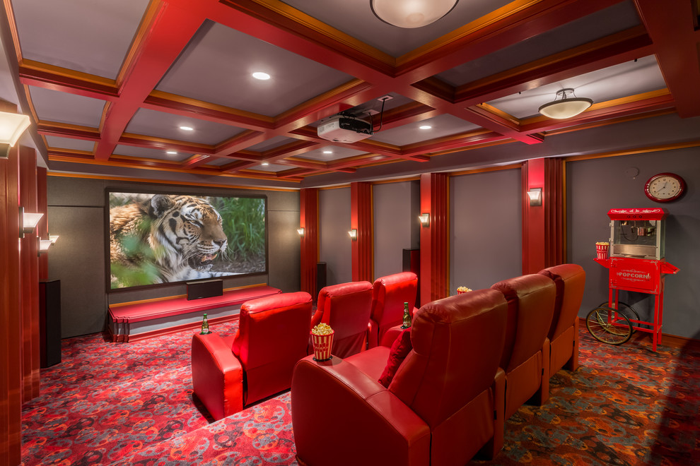 Photo of a classic enclosed home cinema in Seattle with grey walls, carpet, a projector screen, red floors and feature lighting.