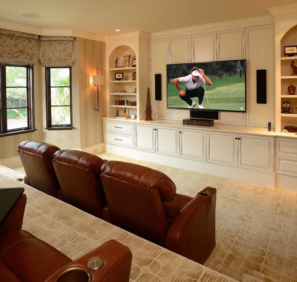 Inspiration for a large mediterranean open concept carpeted and beige floor home theater remodel in Charleston with beige walls and a wall-mounted tv
