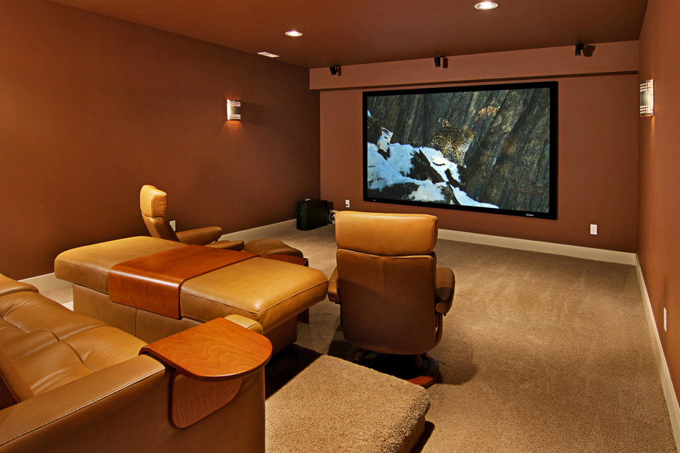 Large contemporary enclosed home cinema in Seattle with orange walls, carpet, a projector screen and beige floors.