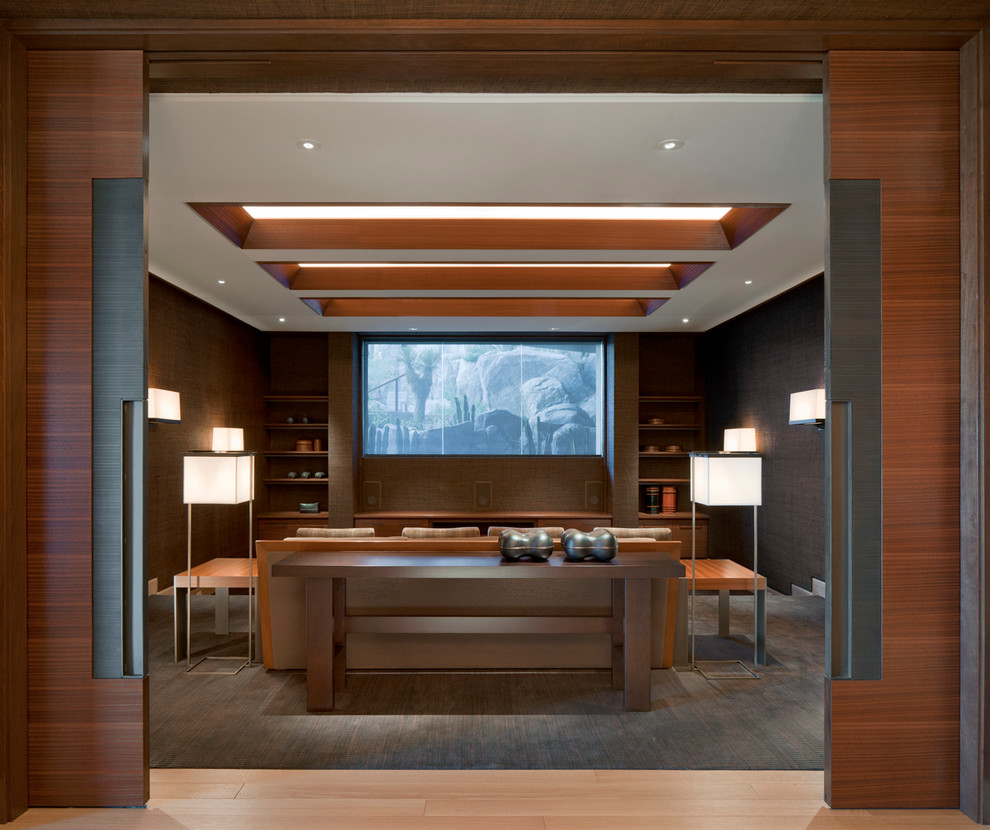 Contemporary enclosed home cinema in Austin with brown walls and a projector screen.