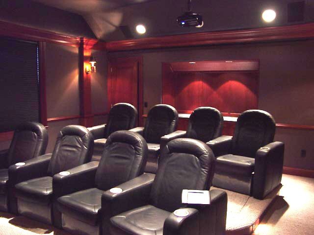 На фото: большой изолированный домашний кинотеатр в стиле кантри с коричневыми стенами, ковровым покрытием, проектором и бежевым полом