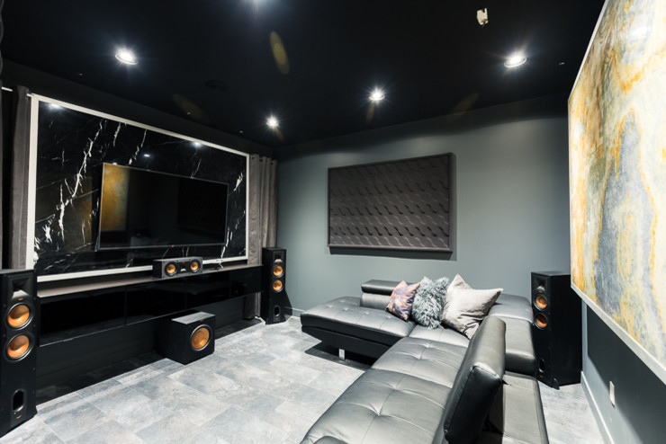 Inspiration for a medium sized modern home cinema in Calgary with black walls, laminate floors, a wall mounted tv and black floors.