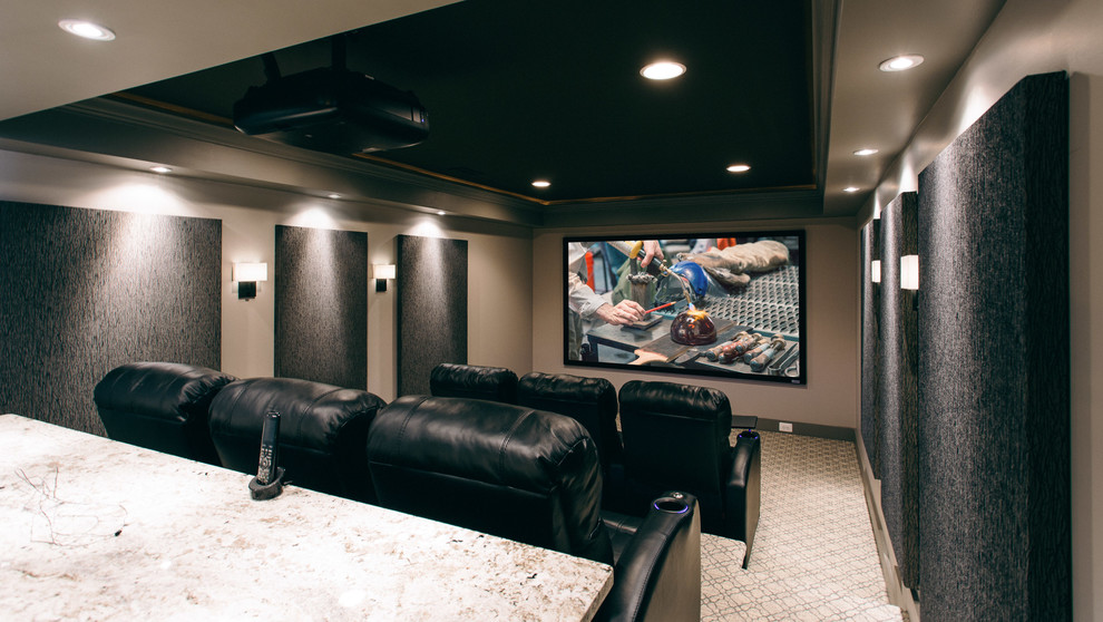 Diseño de cine en casa cerrado moderno de tamaño medio con paredes grises, moqueta, pantalla de proyección y suelo gris