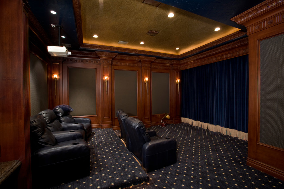 Large traditional enclosed home cinema in Las Vegas with carpet, a projector screen and black floors.