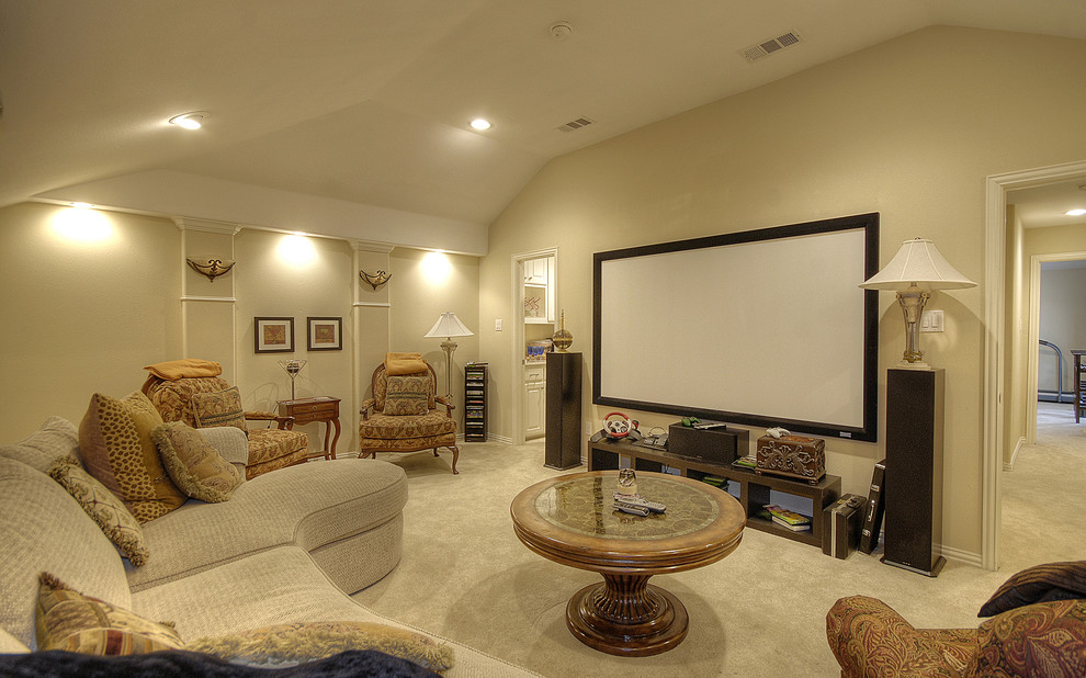 Mid-sized elegant enclosed carpeted and beige floor home theater photo in Dallas with beige walls and a projector screen
