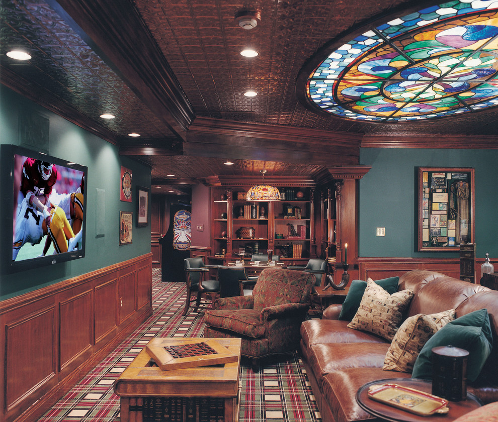 Cette image montre une grande salle de cinéma traditionnelle ouverte avec un mur vert, moquette, un téléviseur fixé au mur et un sol multicolore.