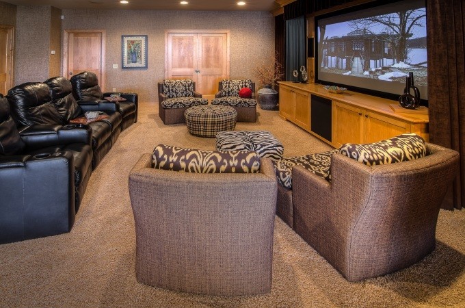 Design ideas for a large eclectic enclosed home cinema in Minneapolis with beige walls, carpet and a projector screen.
