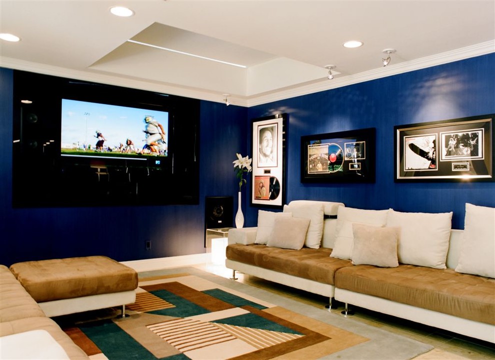 Example of a trendy home theater design in Los Angeles with blue walls