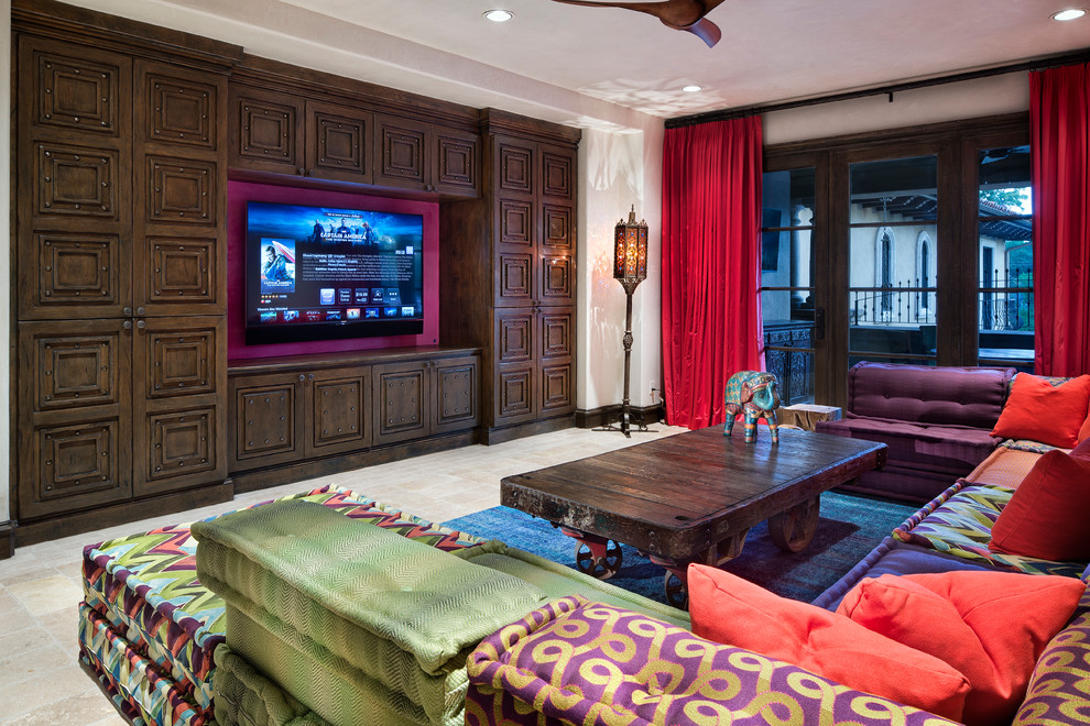 Design ideas for a large mediterranean enclosed home cinema in Houston with a built-in media unit and beige floors.