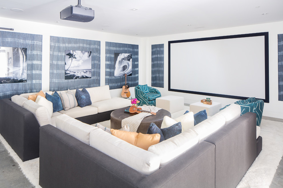 На фото: домашний кинотеатр в морском стиле с белыми стенами, бетонным полом, проектором и серым полом с