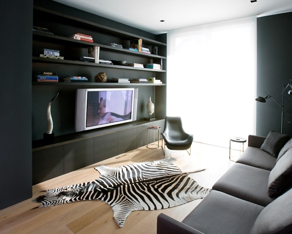 Trendy enclosed home theater photo with a media wall