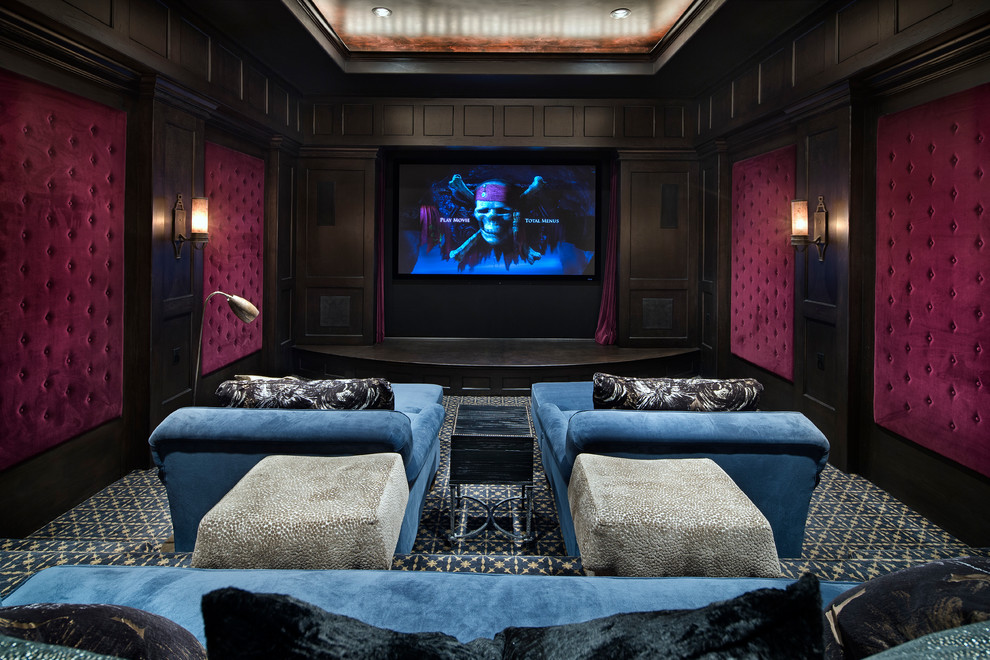 Example of a mid-sized tuscan enclosed carpeted and blue floor home theater design in Houston with red walls and a media wall