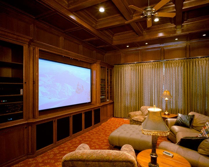 Example of a large classic enclosed carpeted home theater design in Sacramento with brown walls and a media wall