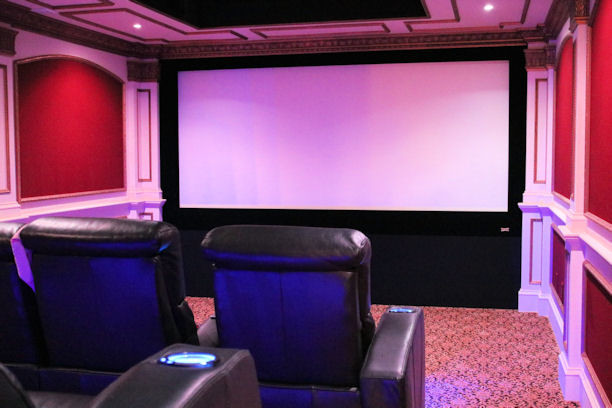 Medium sized modern enclosed home cinema in Boston with carpet and a projector screen.