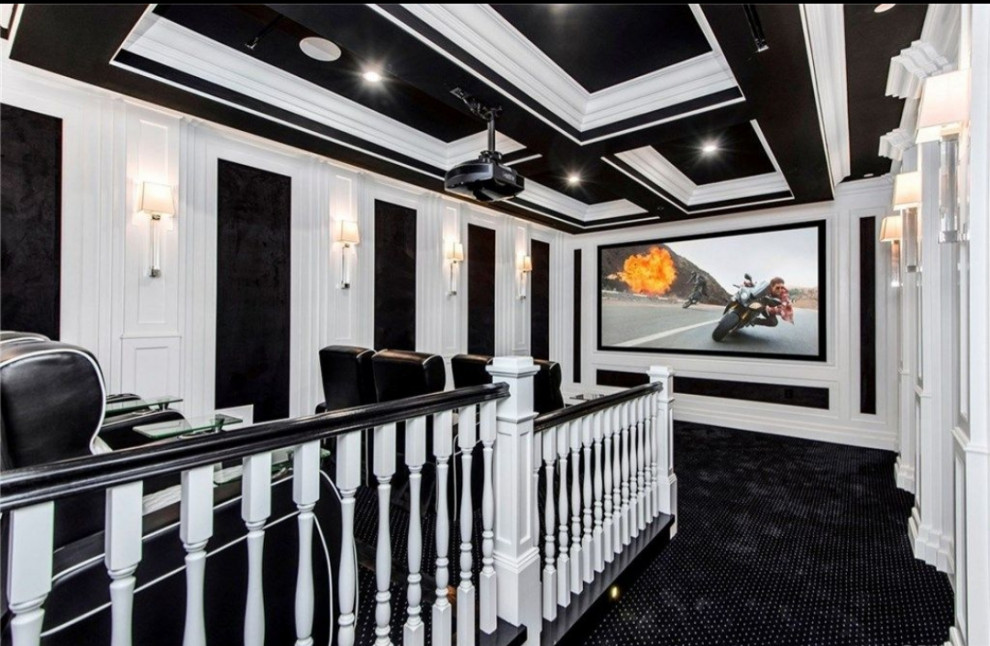 Large elegant enclosed carpeted and black floor home theater photo in Los Angeles with black walls and a projector screen