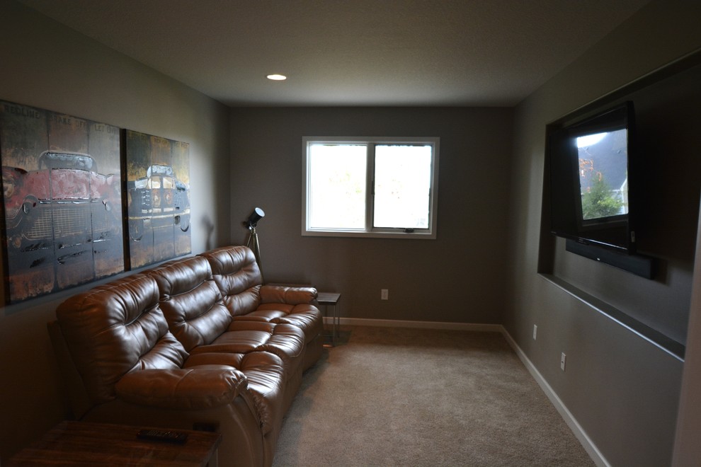 Imagen de cine en casa cerrado contemporáneo de tamaño medio con paredes grises, moqueta y televisor colgado en la pared
