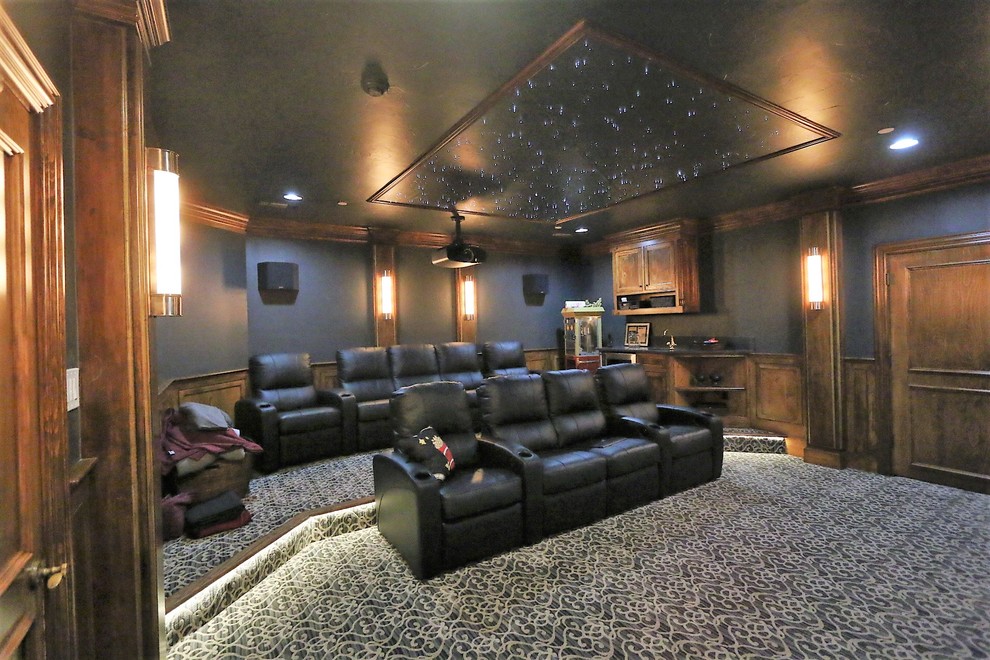 Design ideas for a large traditional enclosed home cinema in Dallas with black walls, carpet and a projector screen.