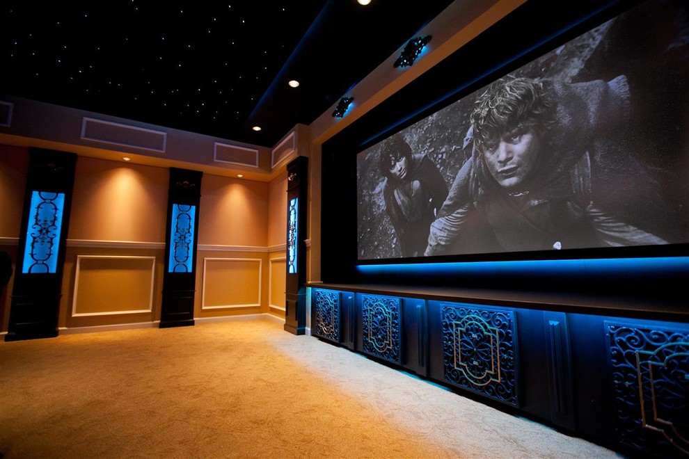 Photo of a medium sized classic enclosed home cinema in Grand Rapids with beige walls, carpet and a projector screen.