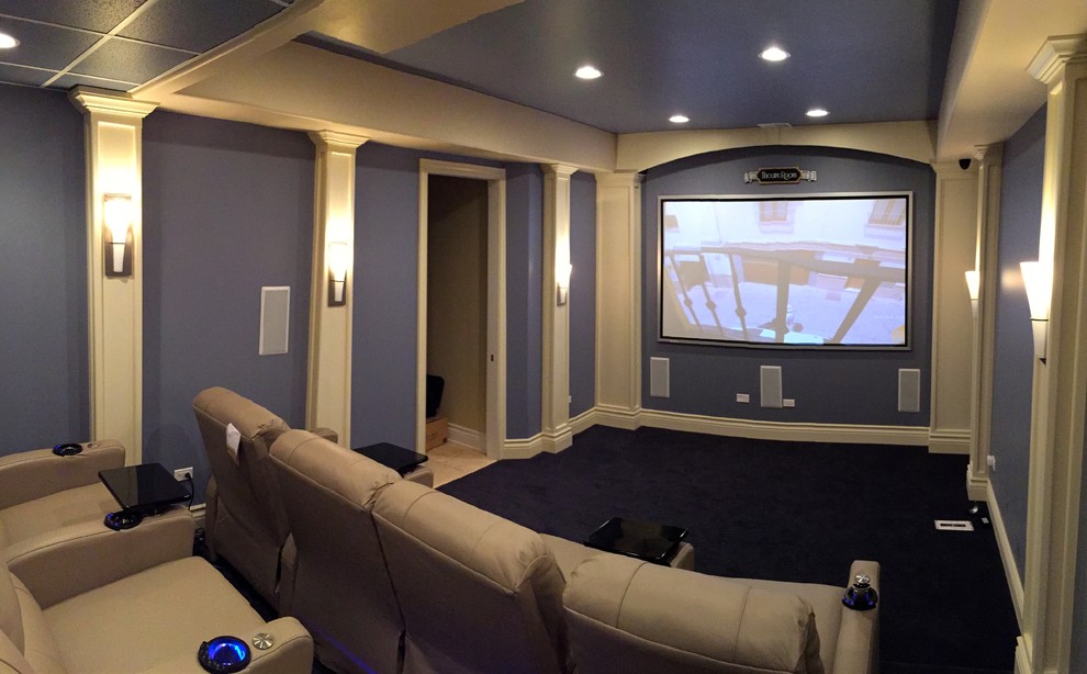 This is an example of a medium sized traditional enclosed home cinema in Chicago with purple walls, carpet, a projector screen and black floors.