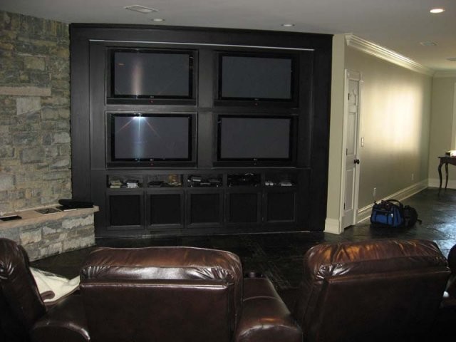 Example of a mid-sized classic open concept slate floor home theater design in Other with beige walls and a media wall