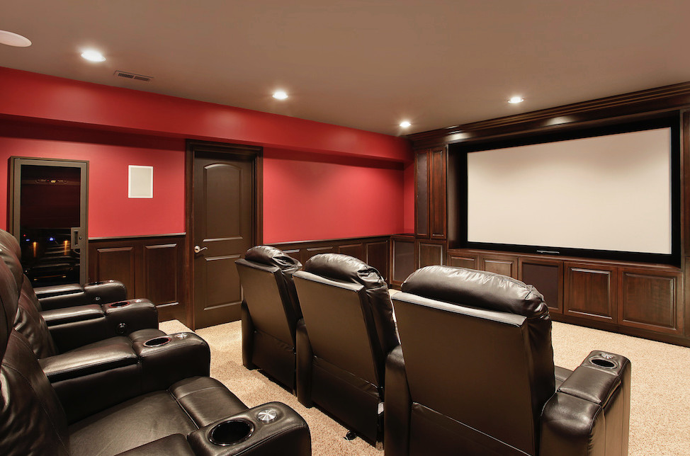 Home theater - mid-sized traditional enclosed carpeted and beige floor home theater idea in Chicago with red walls and a projector screen