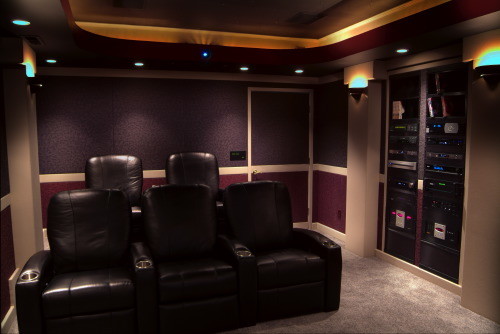 Example of a mid-sized classic enclosed carpeted home theater design in Other with multicolored walls and a wall-mounted tv